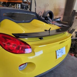 Carbon Fiber Spoiler for the Pontiac Solstice and Saturn Sky, shown installed on the trunk of a yellow Solstice.